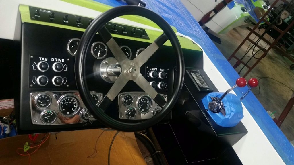 The dashboard with new analog gauges installed; TNT Custom Marine had to employ special software to translate the digital signals from the engine. Note that in this photo the labels for the tabs and drives were erroneously placed; they were later corrected.