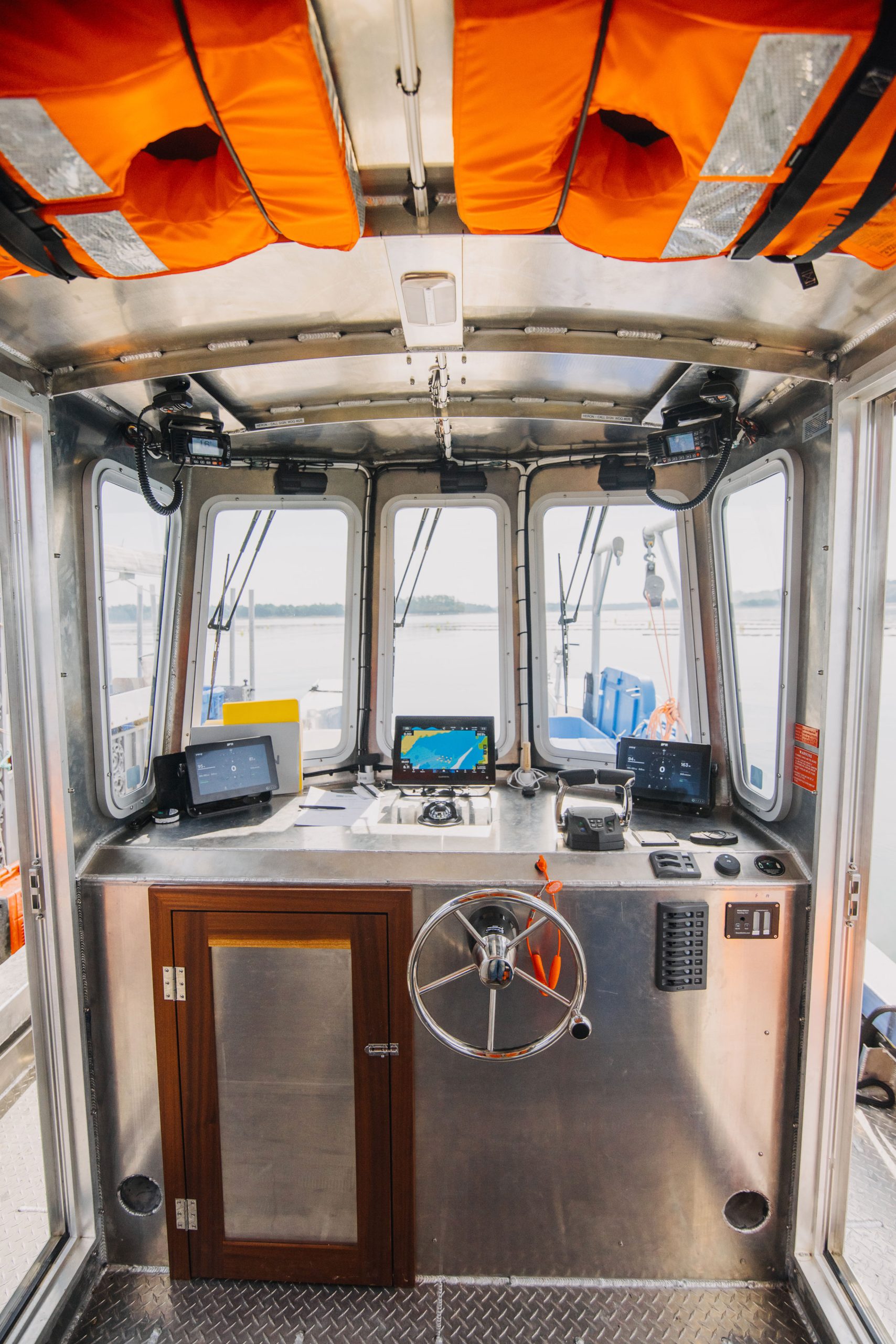 Boat pilothouse with electronic equipment and lifevests.