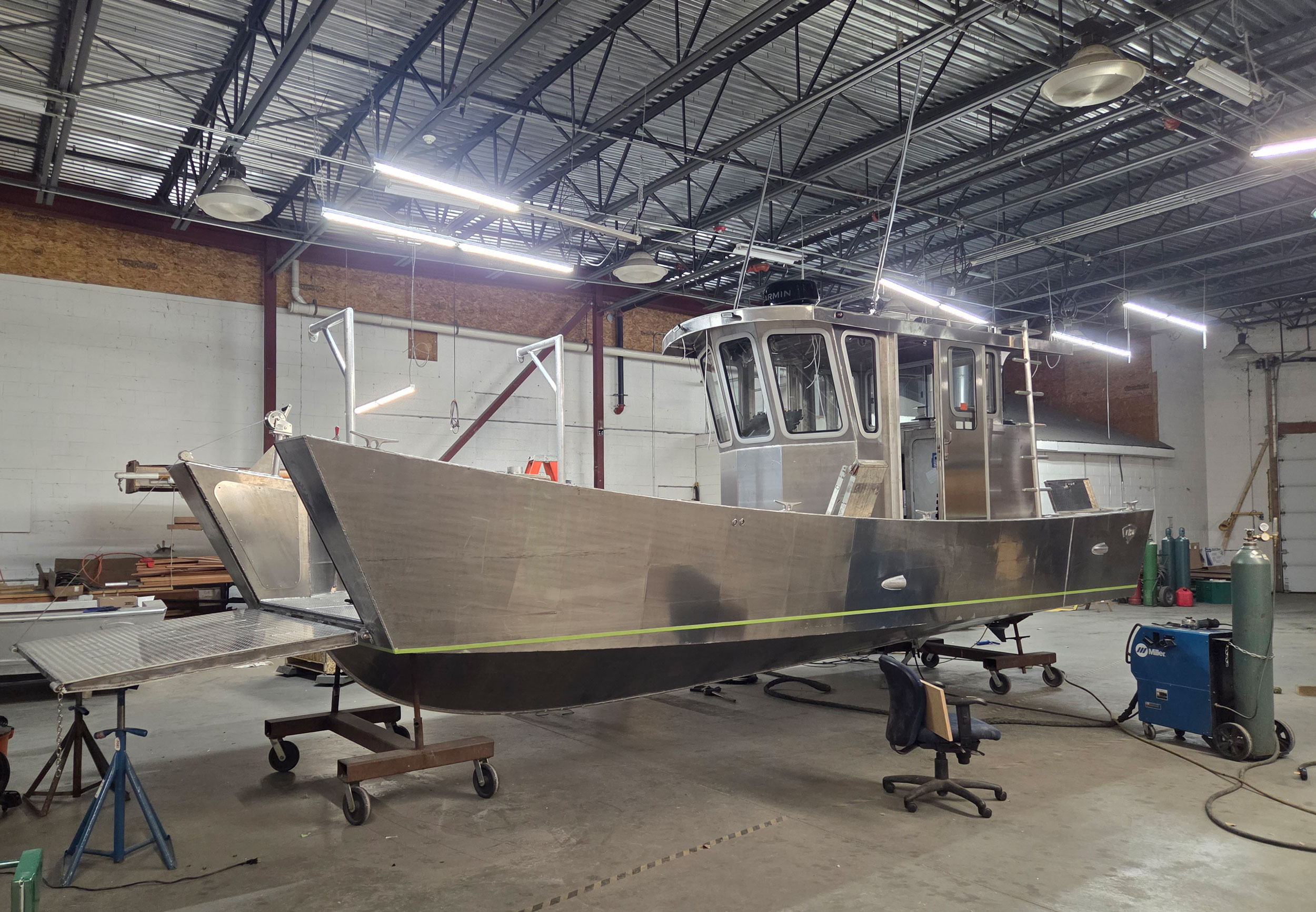 Aluminum power boat on the shop floor.